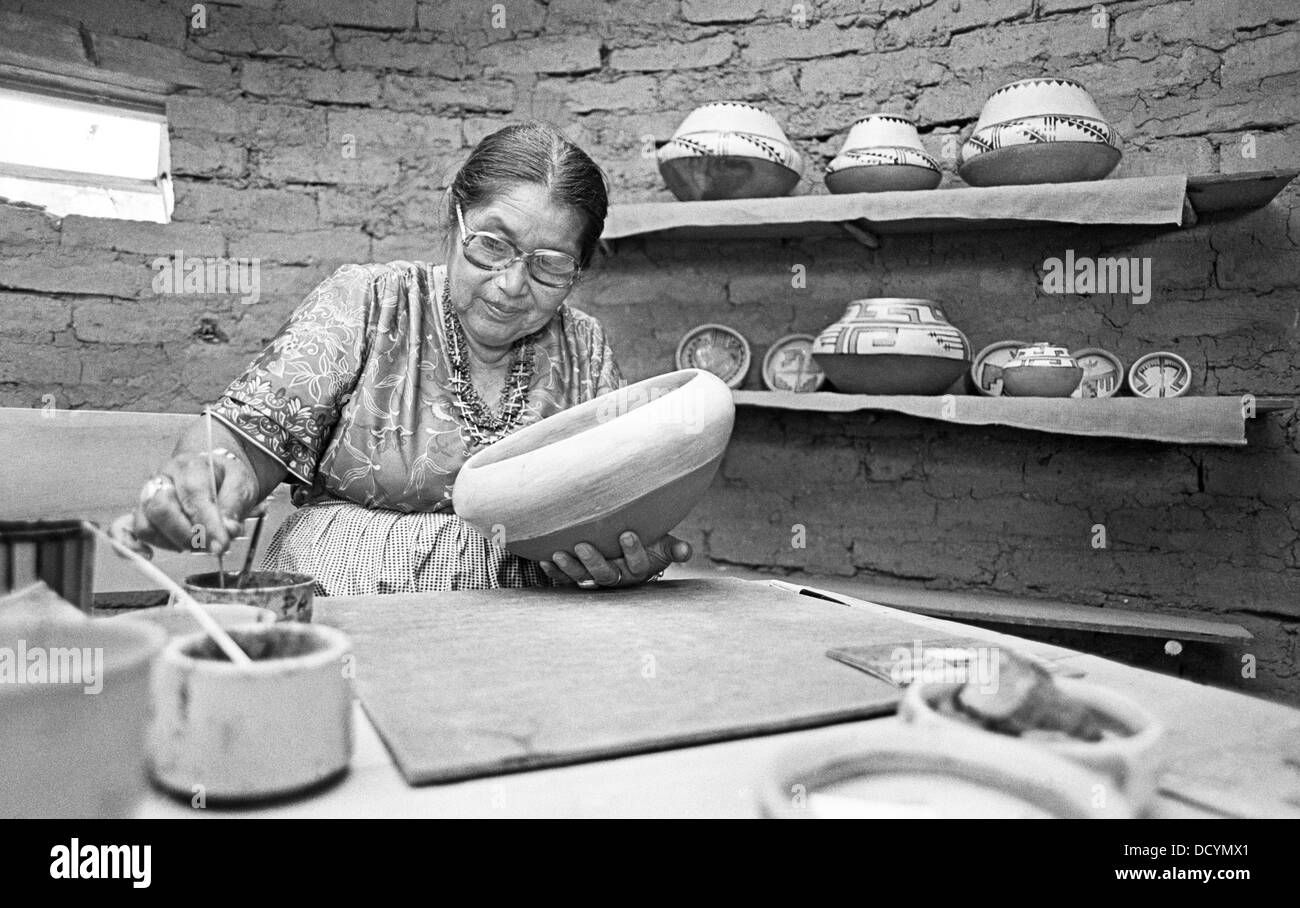 An elderly Indian woman from Jemez Indian Pueblo in New Mexico hand makes traditional Indian pottery, circa 1978 Stock Photo