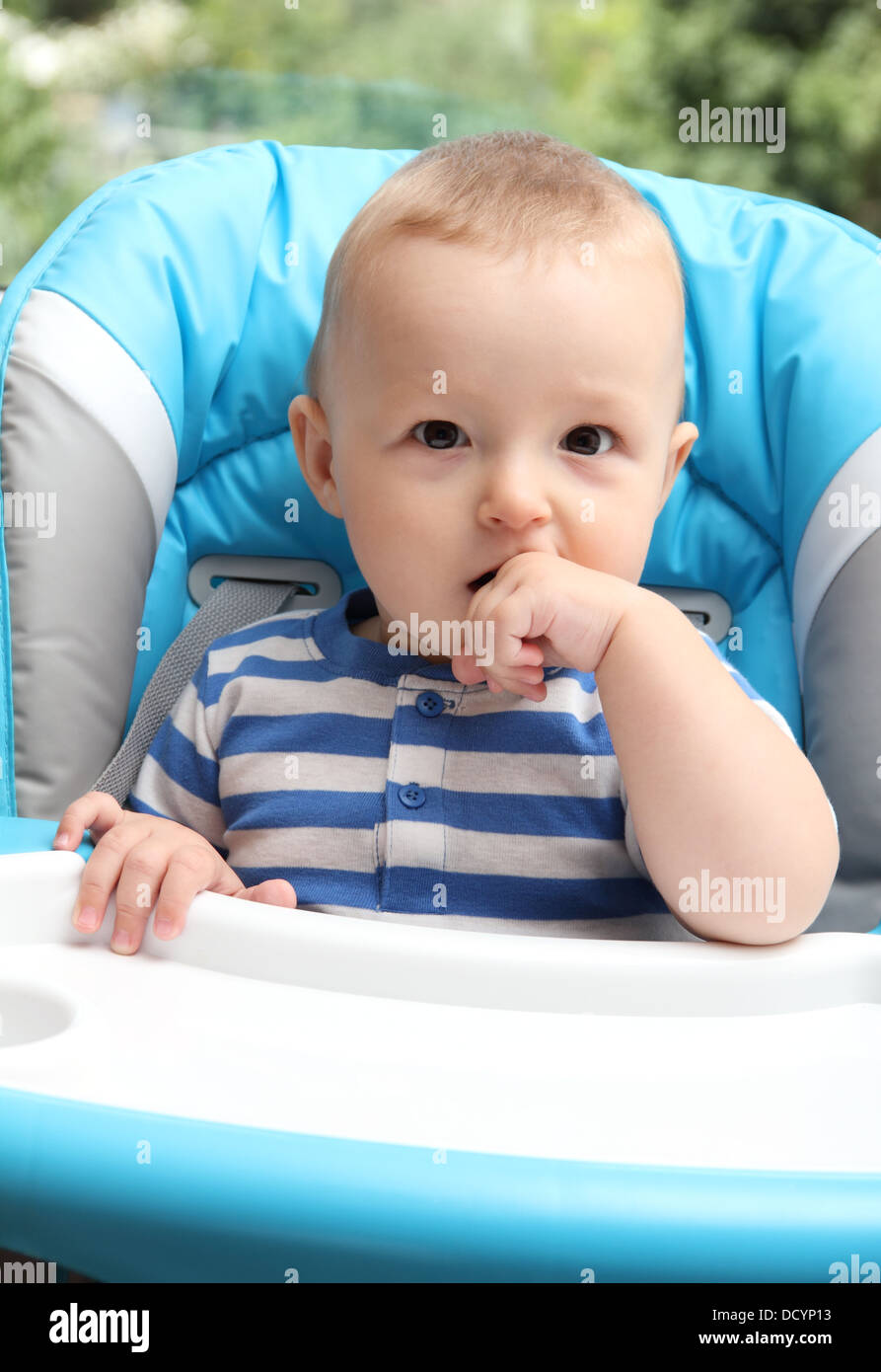 baby sitting in highchair Stock Photo