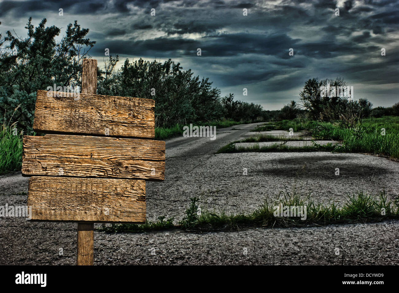 old wooden road sign on a dark deserted road Stock Photo - Alamy