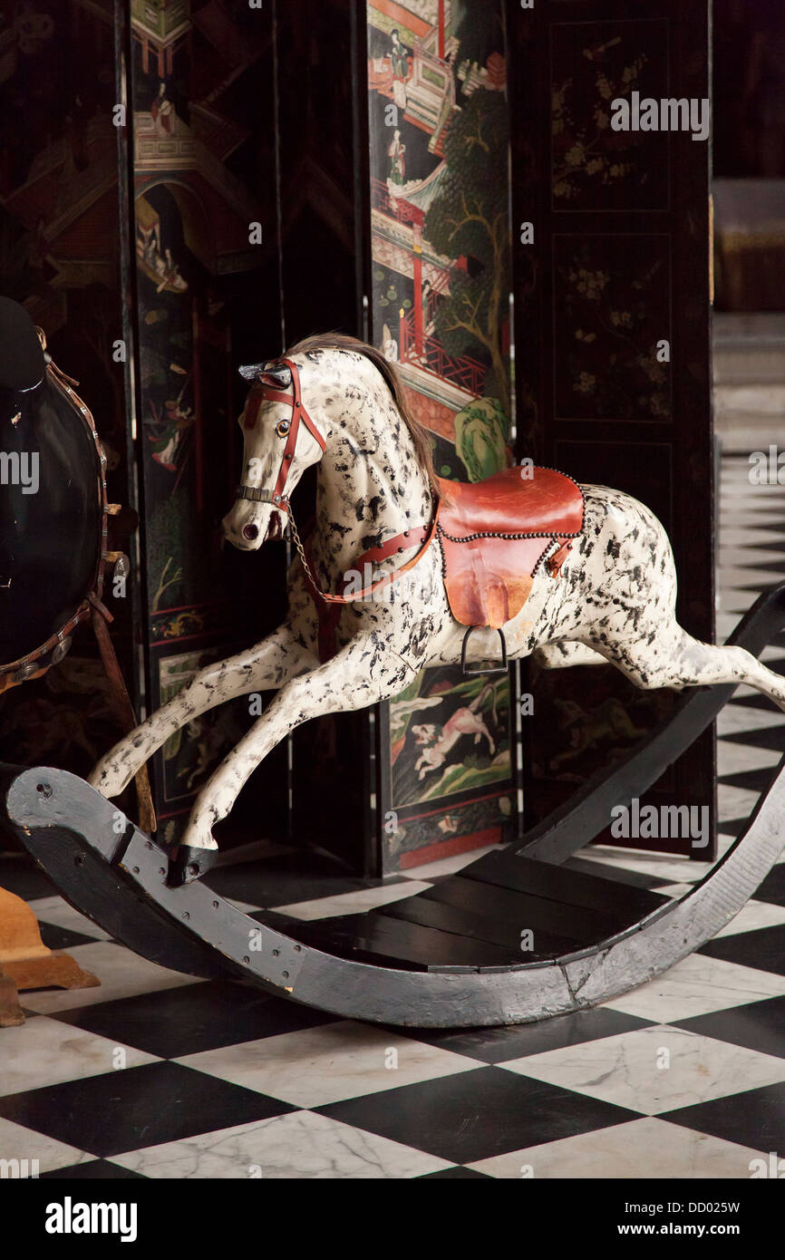 Child's antique rocking horse in front of Screen. Stock Photo