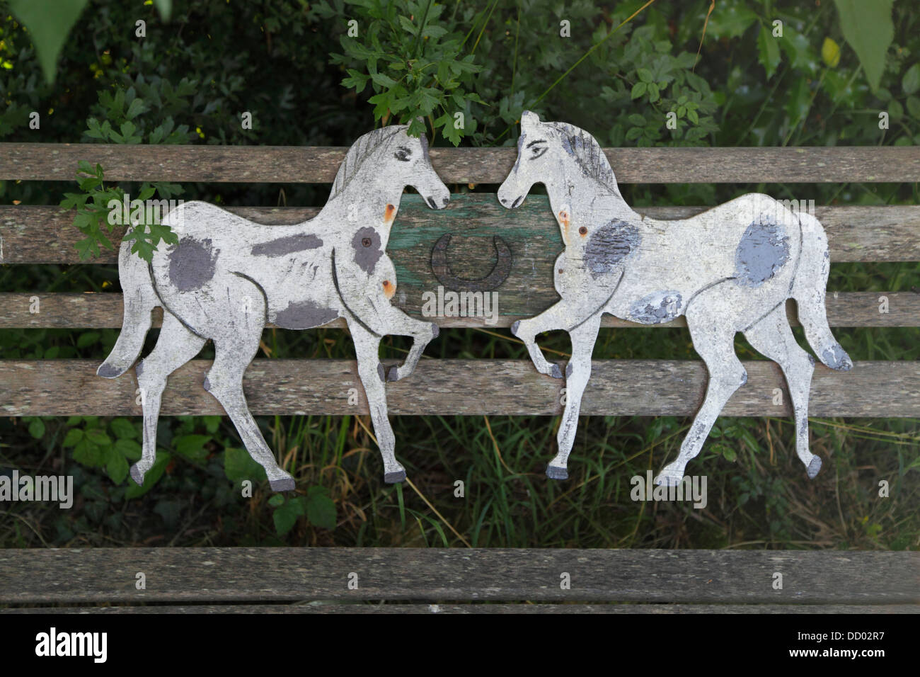 Unusual memorial of horses on a wooden seat in Biddenden churchyard Kent UK GB Stock Photo