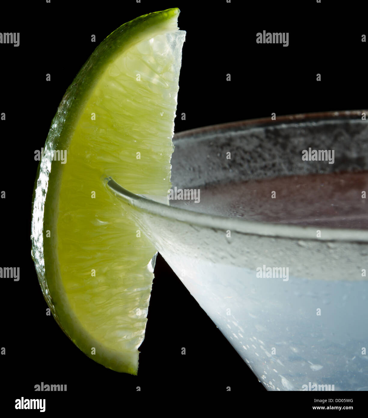 lime wedge on the rim of a martini glass used as a garnish isolated on