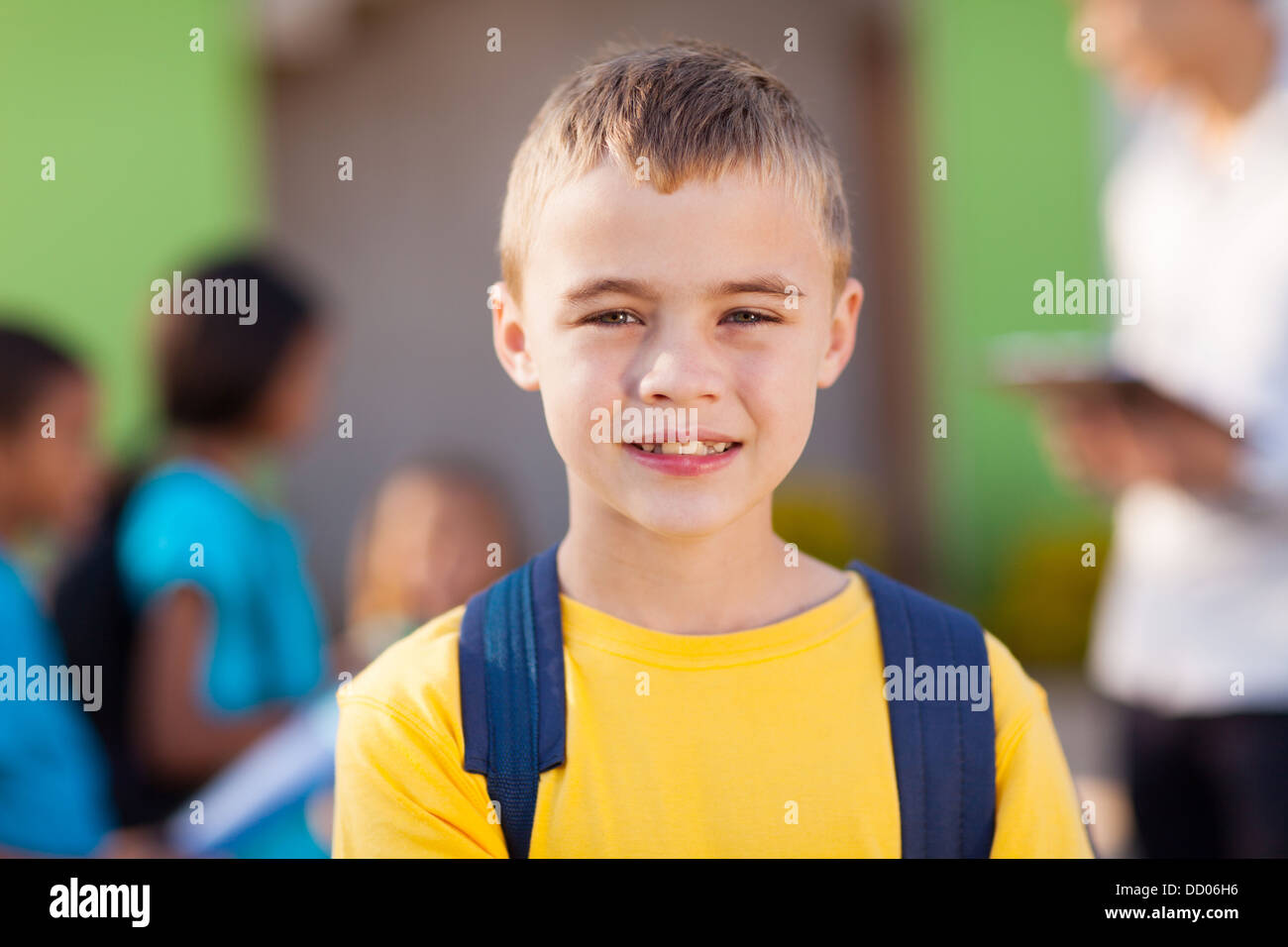 cute male elementary pupil outside classroom Stock Photo
