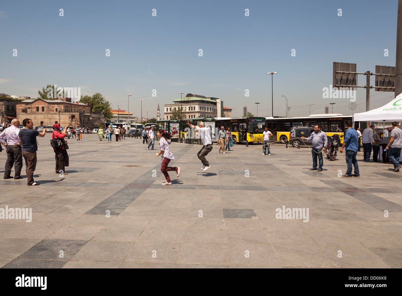 People skipping in a square at Eminonu, Istanbul, Turkey Stock Photo
