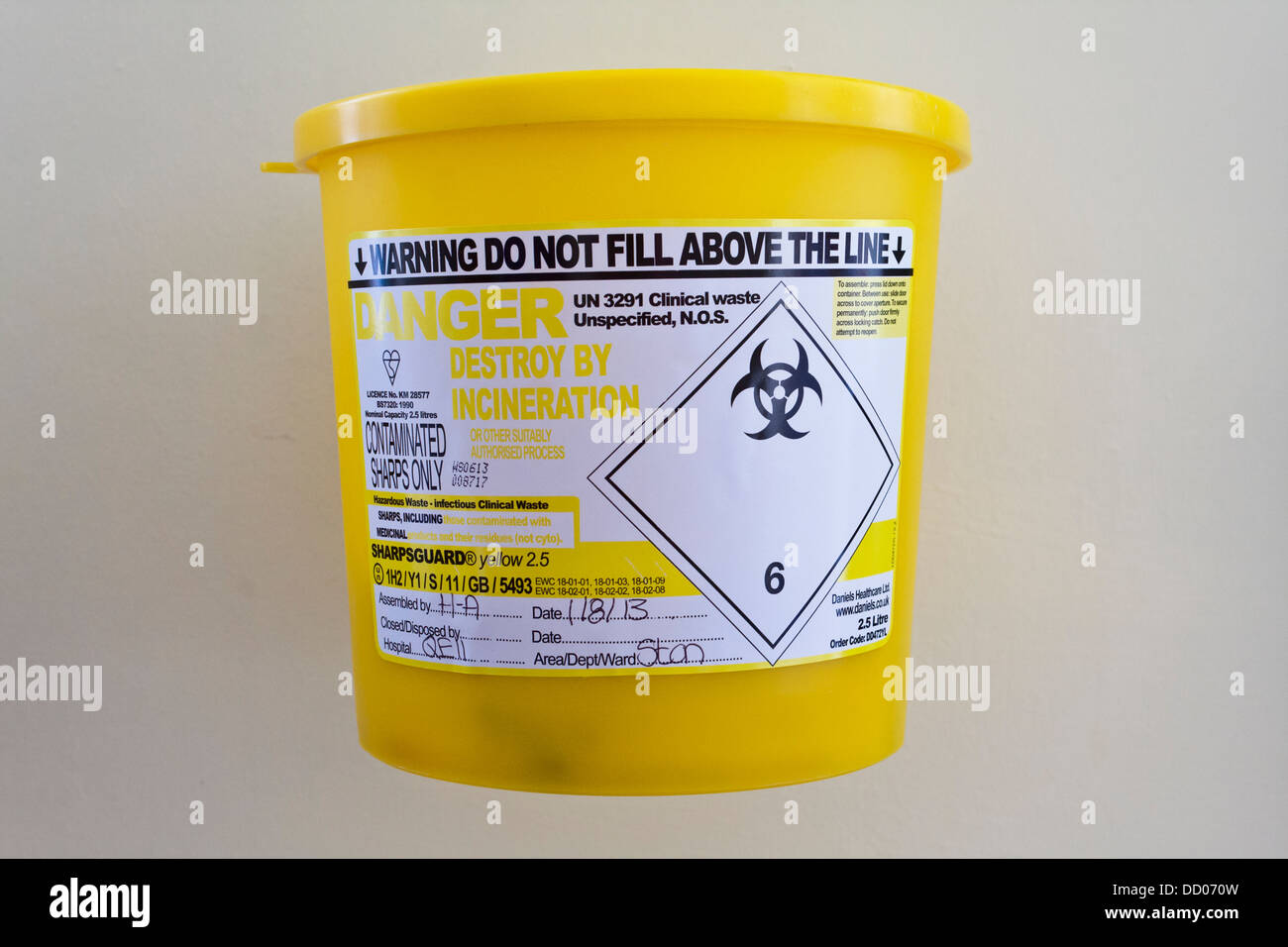 Sharps contminates bin for disposal of used needles on a hospital ward