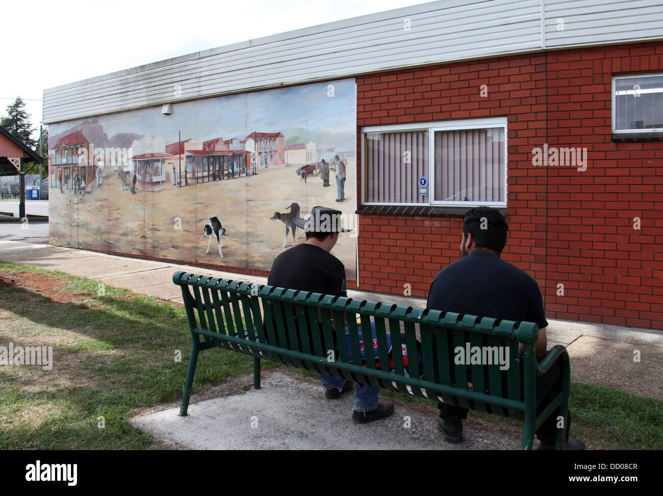 Mural in the Tasmanian town of Sheffield with two men sitting on a public seat Stock Photo
