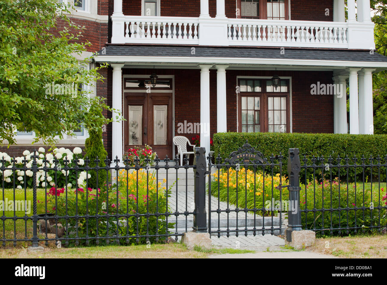 An Old Residence With A Balcony And A Wrought Iron Fence; Trois Rivieres, Quebec, Canada Stock