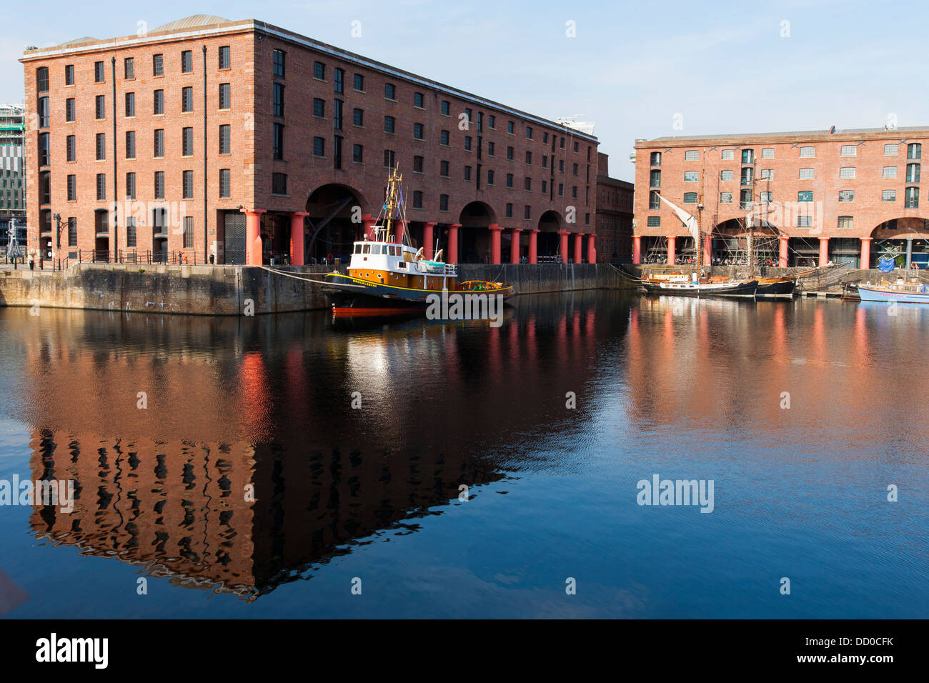 Buildings that make up part of the Albert Dock in Liverpool port and harbor reflect in the water Stock Photo