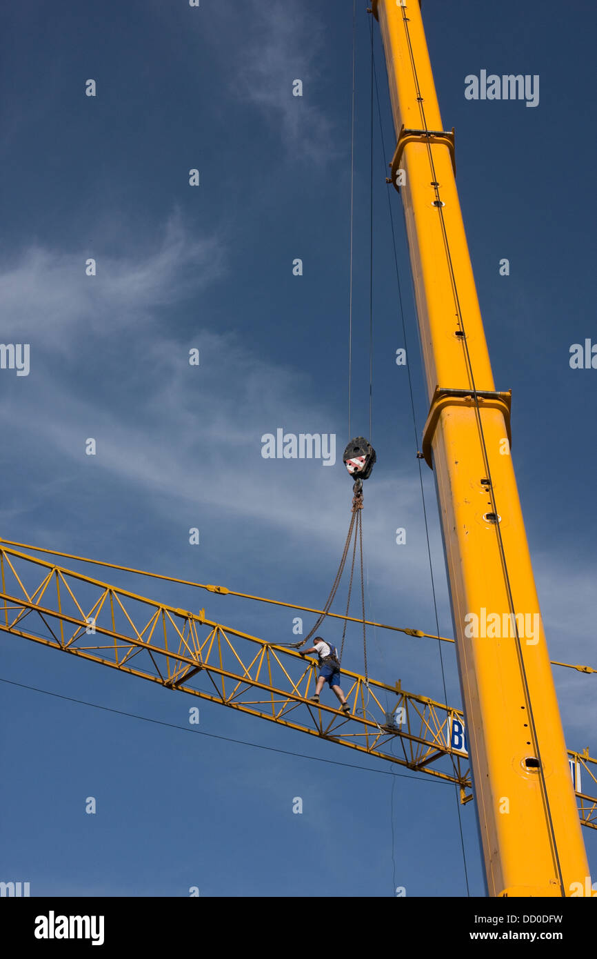 view of crane lifting crane boom into position for assembly with ...