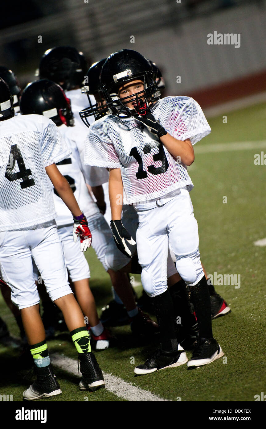 Young football boy looking at the coach. Stock Photo