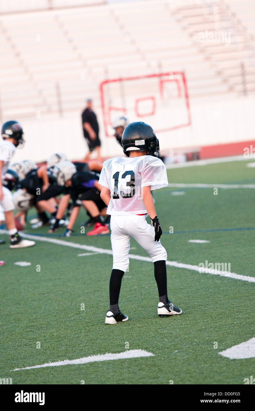 Youth football player on defense Stock Photo