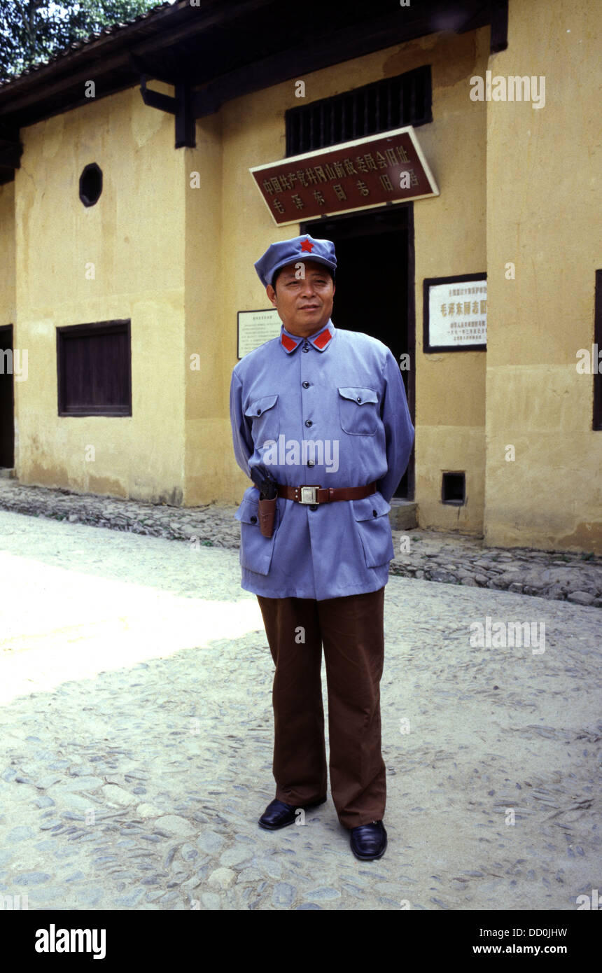 Chinese tourist wears rented revolutionary soldier costume as while visiting the Former Revolutionary Headquarters in Jingang Shan town Jiangxi province China Stock Photo