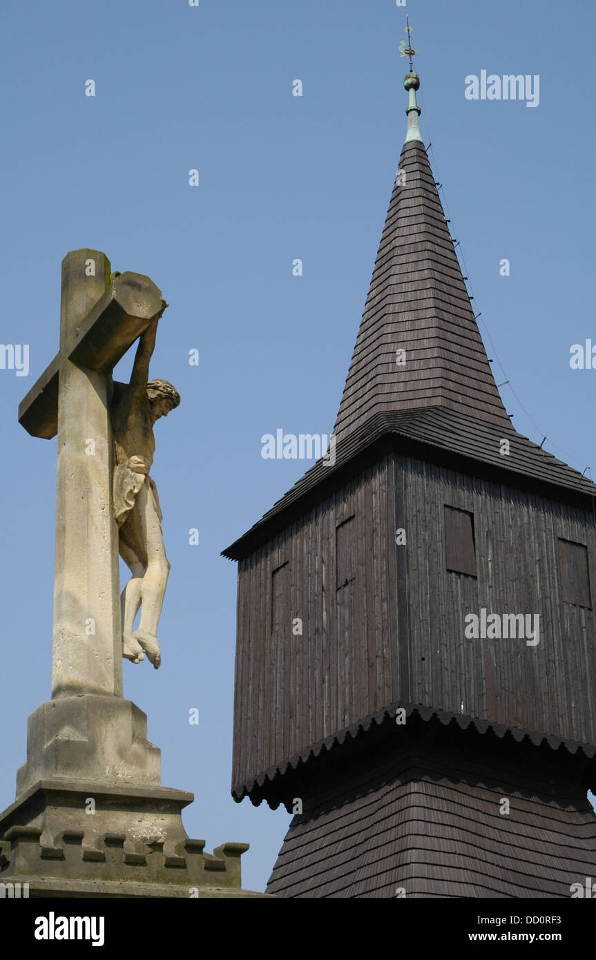 View of the old wooden bell tower of the Roman Catholic church designed in the vernacular folk architecture of the Carpathians in Rtyne v Podkrkonosi a small town in the Trutnov District, the Czech Republic Stock Photo