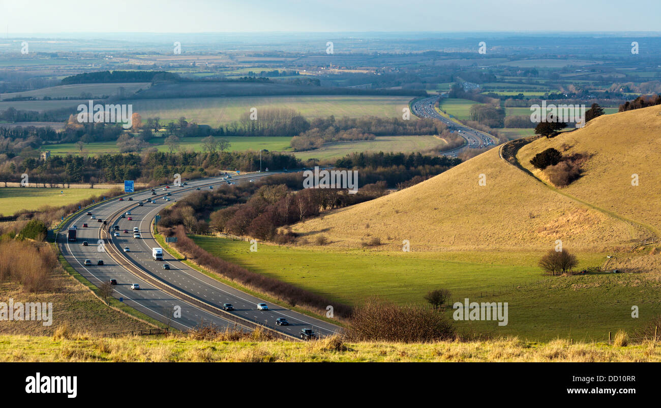 The M40 Junction 6 looking north west snaking through the Aston Rowant Cutting (or Stokenchurch Gap), mirrored in the hill path. Stock Photo