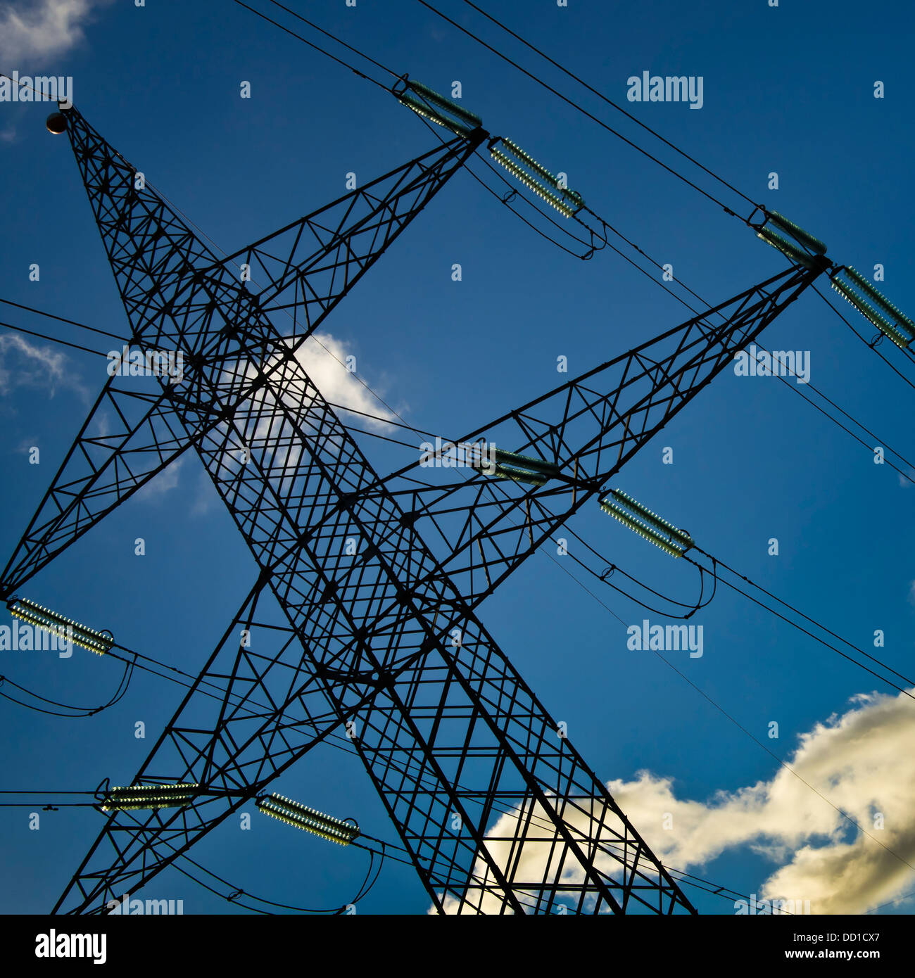 High voltage Tower, tilt viewpoint, clean blue sky Stock Photo - Alamy