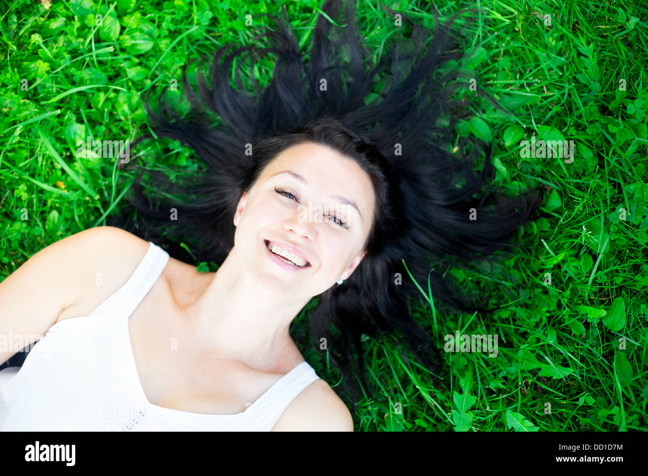 View of Beautiful girl lying on a grass Stock Photo - Alamy