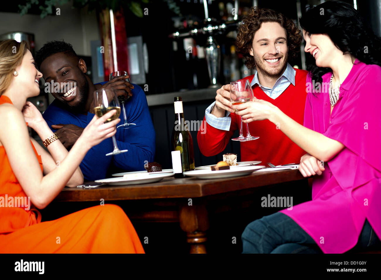 Friends enjoying snacks with drinks in a bar Stock Photo Alamy