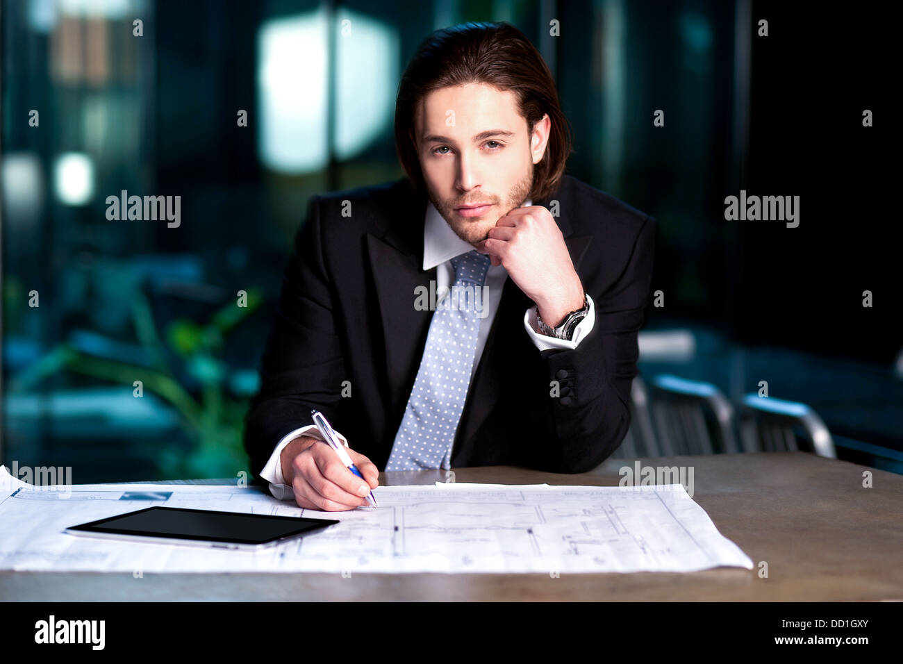 Handsome young businessman busy with his project plan Stock Photo - Alamy