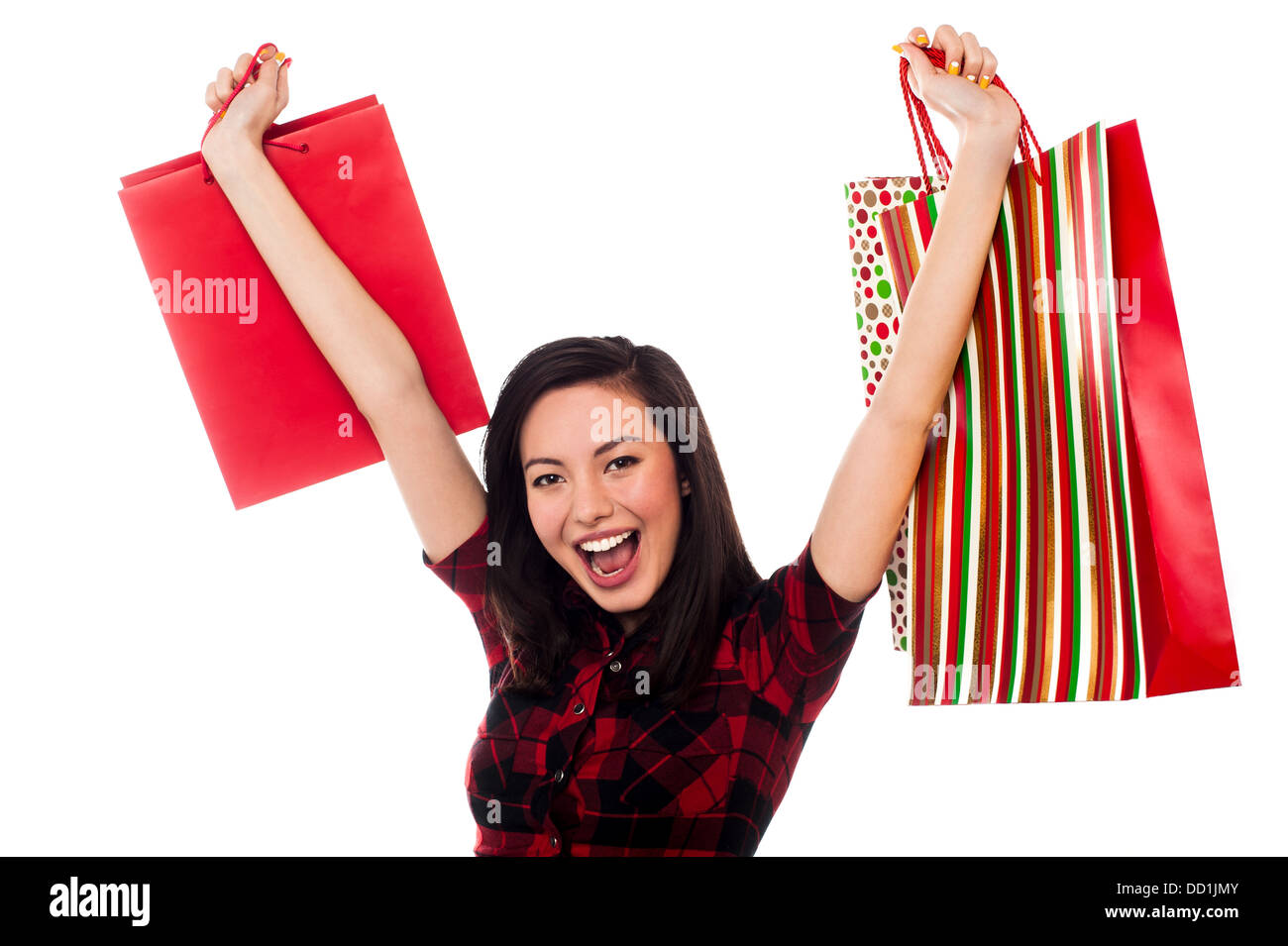 young girl holding shopping bags, filled with excitement Stock