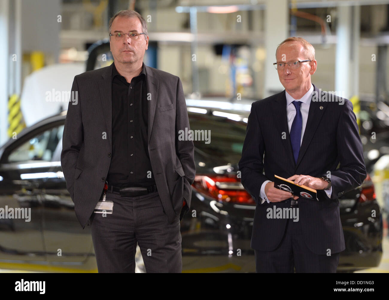 Ruesselsheim, Germany. 22nd Aug, 2013. Karl-Thomas Neumann (R), chairman of the Adam Opel AG, and Wolfgang Schäfer-Klug, the employee organization head look around during the presentation of the new Opel Insignia in the Opel parent plant in Ruesselsheim, Germany, 22 August 2013. The car builder overhauled its almost five-year-old flagship car. Photo: ARNE DEDERT/dpa/Alamy Live News Stock Photo