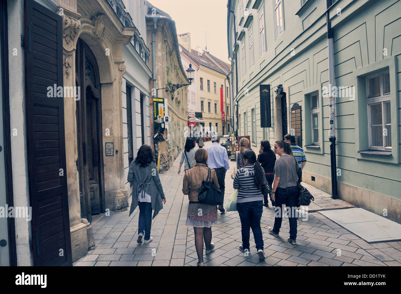 Tourists walking down cobblestone street In Bratislava Old Town, Slovakia, eastern Europe Stock Photo