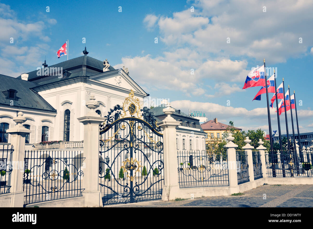 Grassalkovich Palace, Slovakia, Bratislava, Baroque facade with Slovakian flags lining the fence Stock Photo