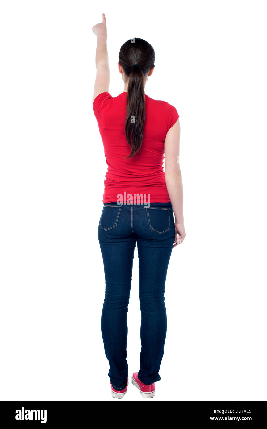 Teenage girl facing wall and pointing at something Stock Photo Alamy