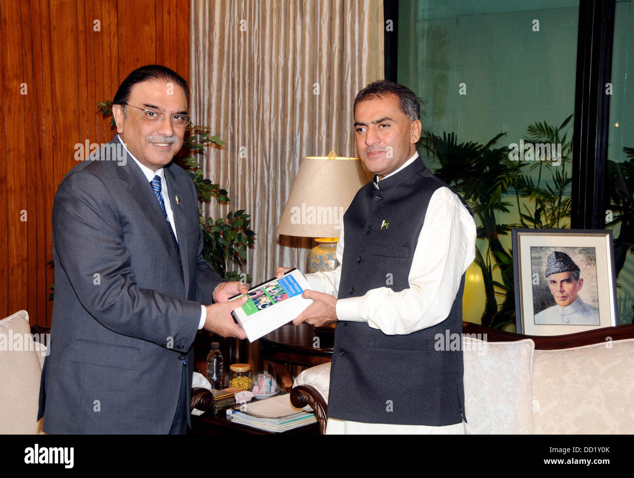 Islamabad, Pakistan. 23rd Aug, 2013. syed muhammad amin shah rashdi presenting his book to prresident asif ali zardari at the president palace 23 august 2013   Handout by Pakistan informtion department      (Photo by PID/Deanpictures/Alamy Live News) Stock Photo