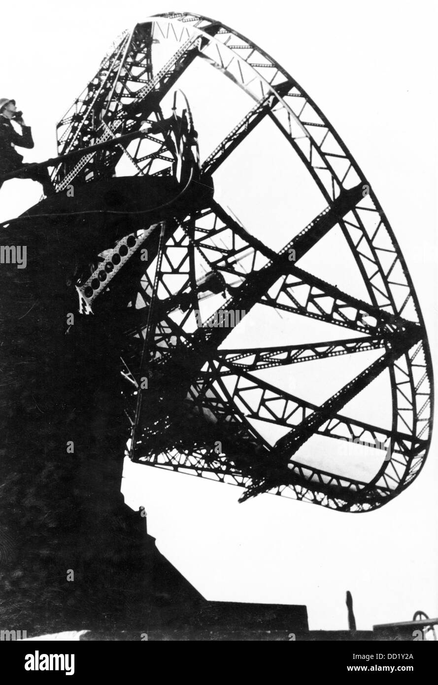 A 'Würzburg' radar in use for antiaircraft defense in May 1944. Place unknown. The Nazi Propaganda! on the back of the picture is dated 16 May 1944: 'Attention! We report on the situation in the air! The warning from the ether. The goliath of the air space. It transmits invisible magnetic pulses into the space that detect the incoming enemy a long time before he reaches the target and do not release him again. This goliath transmits with speed of sound the direction, altitude, and flight path of the enemy machines. The terrorist aircraft does not find any shelter in front of this magnetic eye  Stock Photo