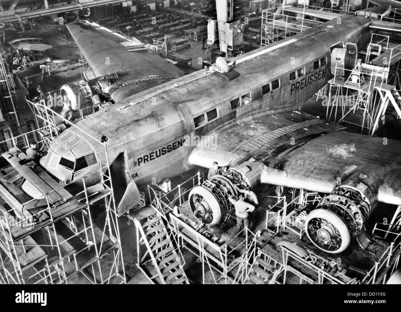 A Junkers Ju 90 type V2 'Preussen' under construction at the Junkers factory in Dessau, Germany, around 1938. Junkers Flugzeug- und Motorenwerke AG (Junkers Aircraft and Motor Manufacturing AG) was one of the leading defense industry manufacturer in the Third Reich. The manufacturer writes on the back of the picture: 'Final assembling of an airliner Junkers Ju 90. The picture shows one of the aircrafts that can hold 40 passengers and offers maximum comfort, built at the request of the German Lufthansa. Fotoarchiv für Zeitgeschichte Stock Photo