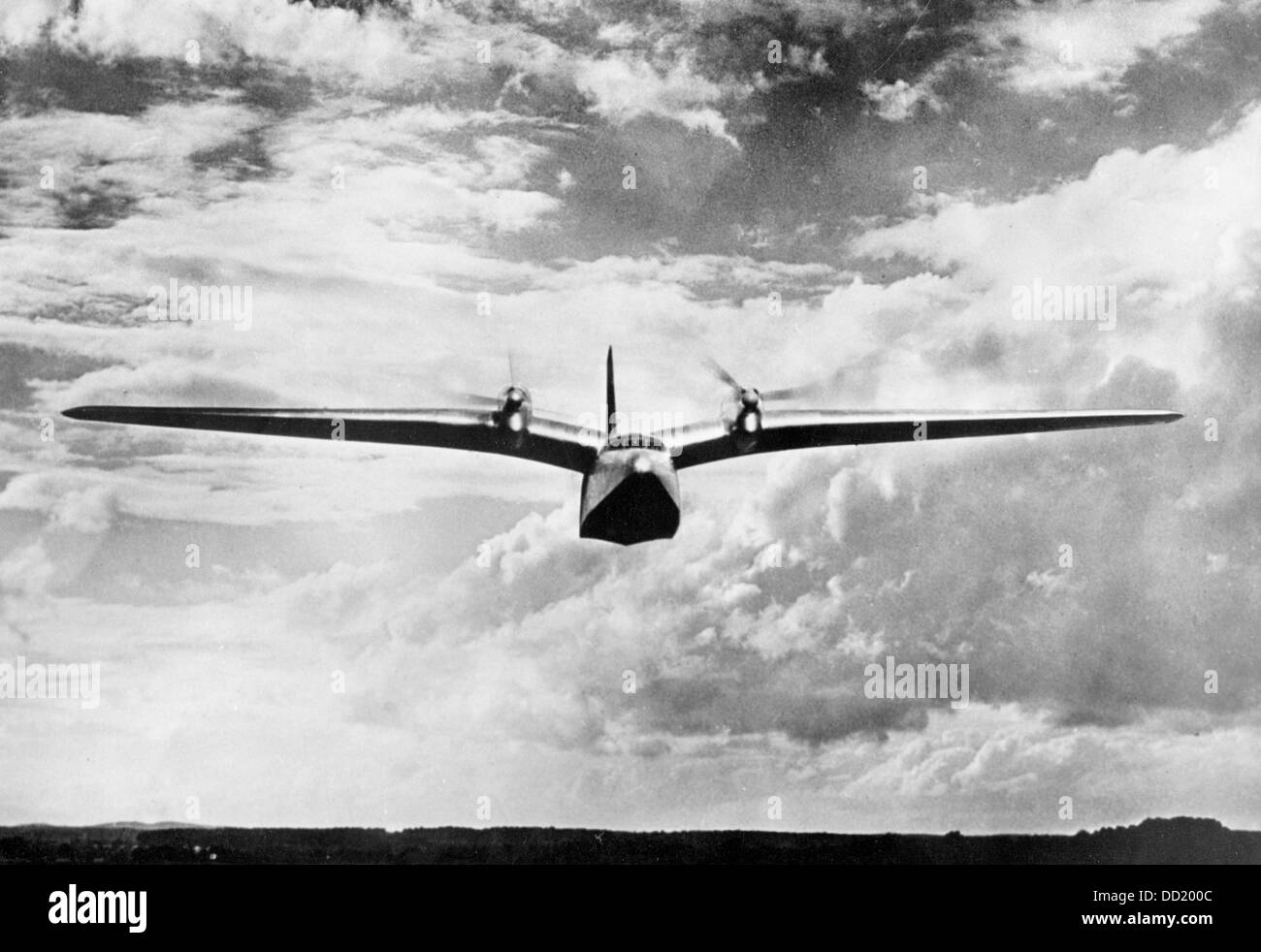 A flying boat of the type Do 26 produced by Dornier Flugzeugwerke (Dornier Aircraft Manufacturer) during a presentation at the Müggelsee in Berlin on 1 September 1938. The Dornier Do 26 was built starting in 1937 and was used for transatlantic flights of the German Wehrmacht from 1938 to 1944. The Nazi Propaganda! on the back of the picture is dated 1 September 1938: 'Presentation of the transatlantic flying boat 'Do 26' at the Müggelsee near Berlin on Thursday, 1 September. - The 'Do 26' in flight. The four-engine flying boat was constructed for non-stop flights over the Atlantic Ocean. The m Stock Photo