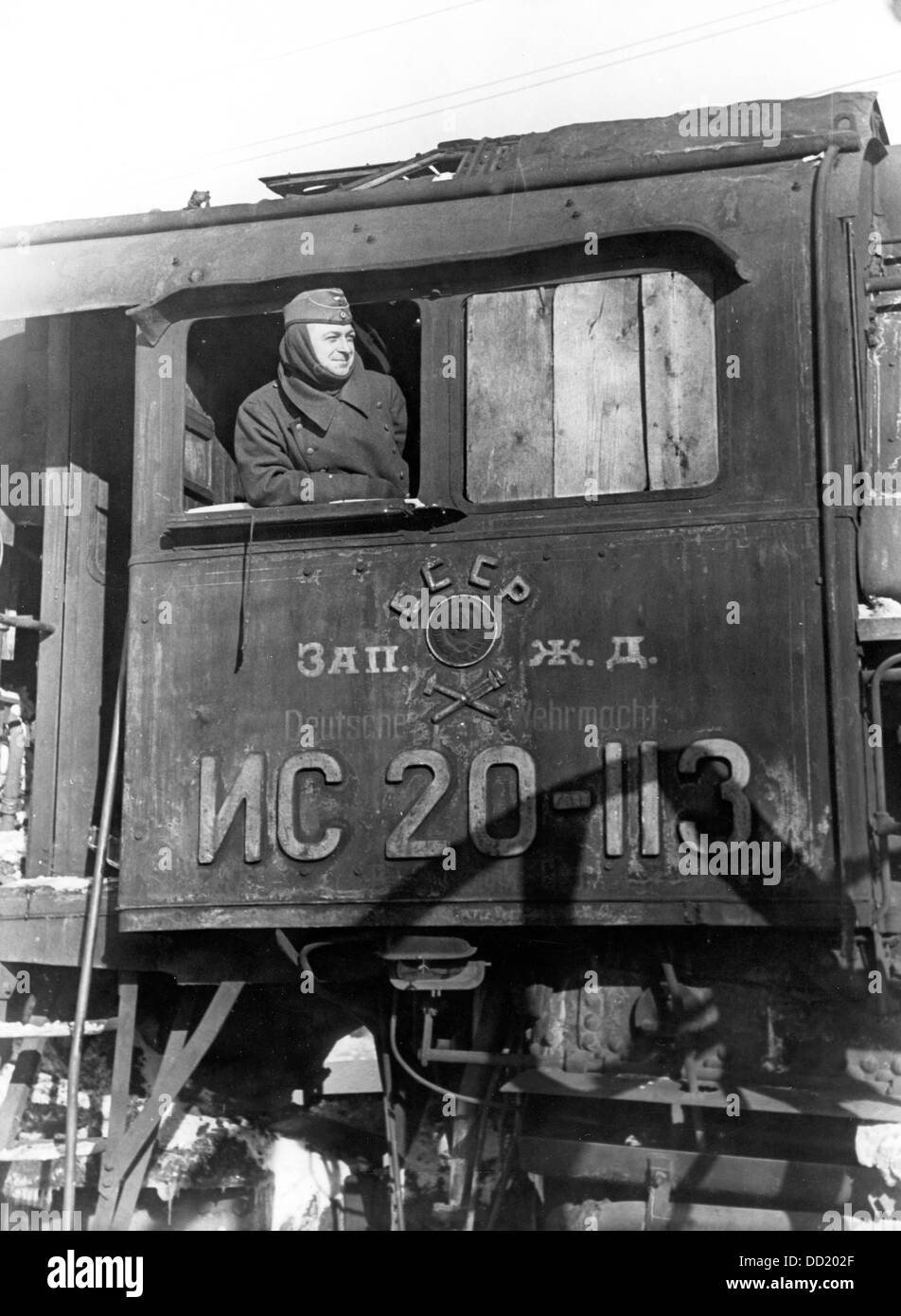A German railway employee is pictured in a captured Russian locomotive in the locomotive depot in Smolensk, Russia, in February 1942. Next to the Russian writing, the words 'Deutsche Wehrmacht' are printed. Photo: Bildarchiv der Eisenbahnstiftung/RVM (minimum fee 60 euros) Stock Photo