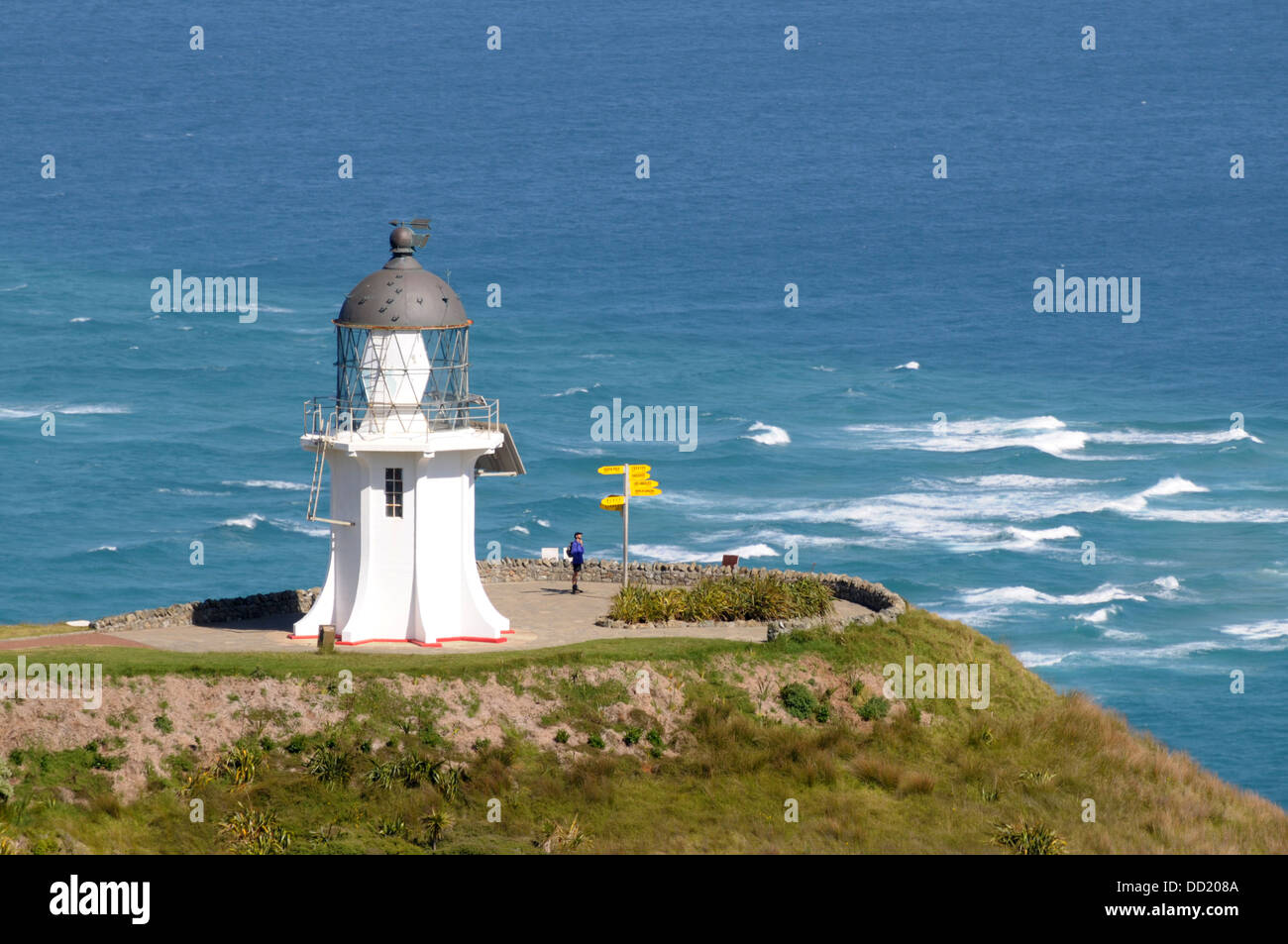 The lighthouse which stands at Cape Reinga -the Northern most tip of NZ - facing the South Pacific Ocean  Ocean Stock Photo