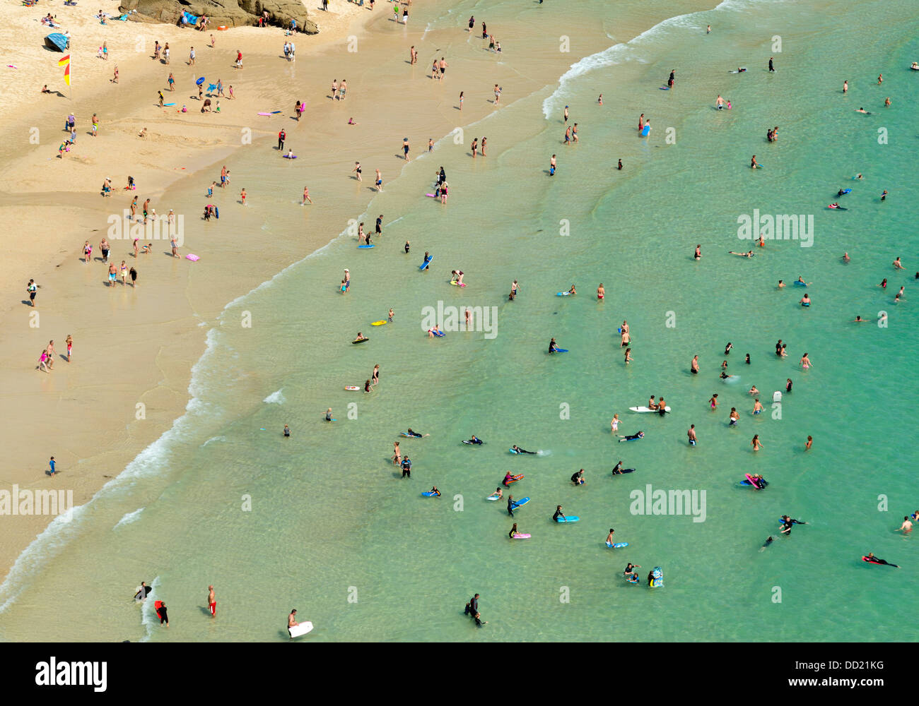 Looking down on lots of body boarders, swimmers and paddlers, Porthcurno beach, Cornwall England. Stock Photo