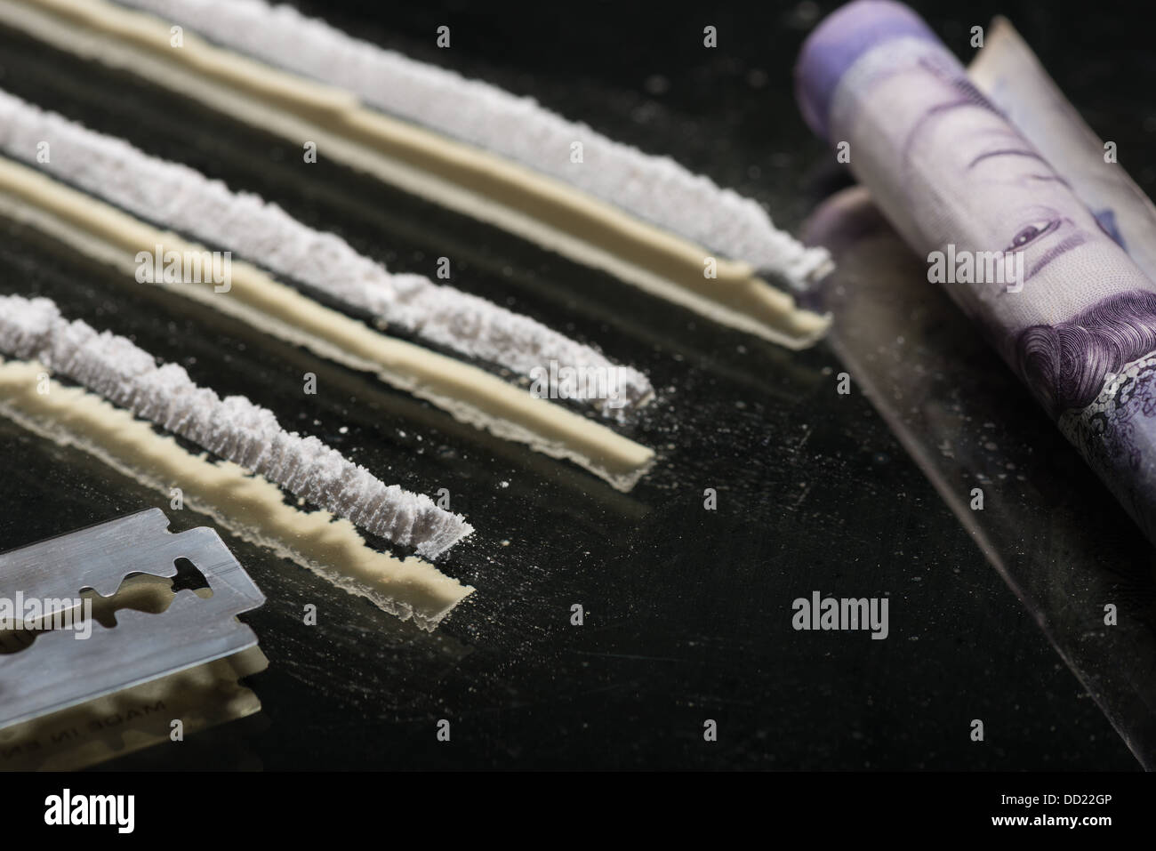 Drug addiction lines rows of powdered cocaine ready to be snorted representing a bad drug habit out of control life destroying Stock Photo