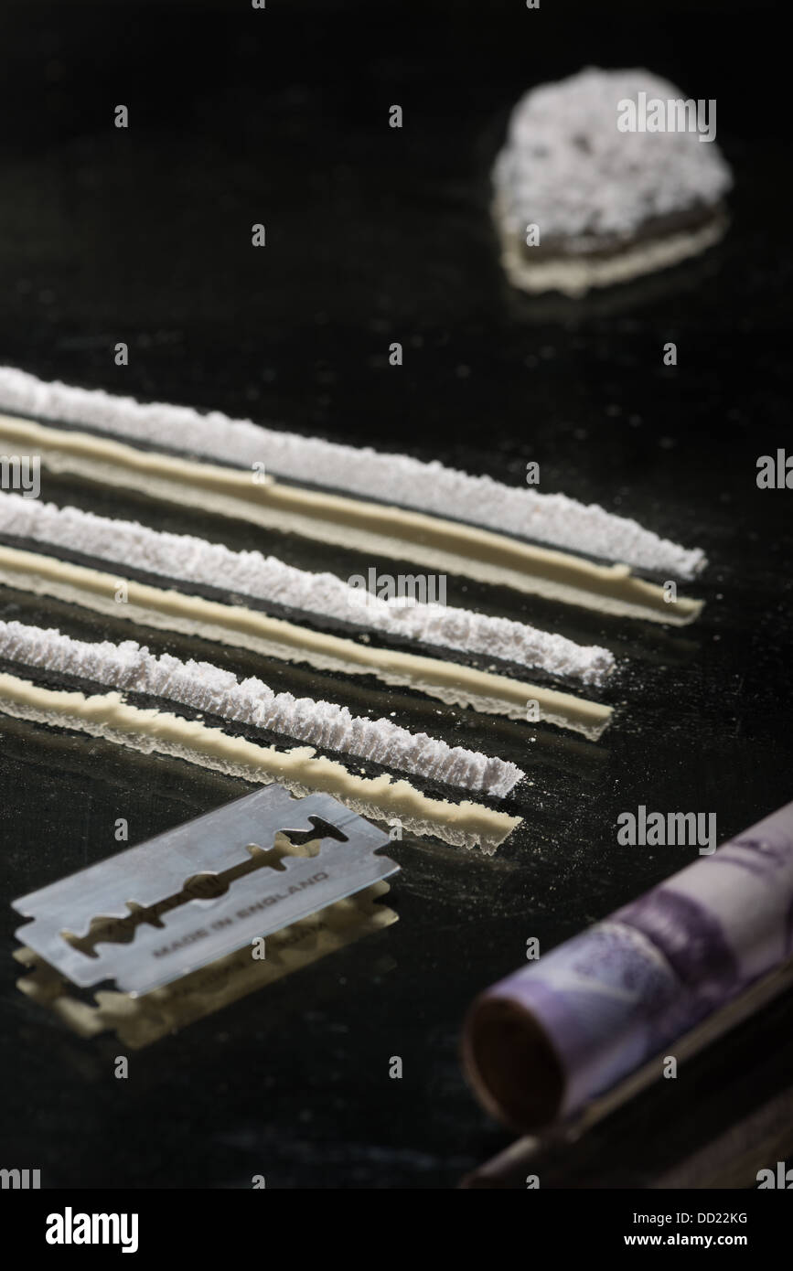 Drug addiction lines rows of powdered cocaine ready to be snorted representing a bad drug habit out of control life destroying Stock Photo