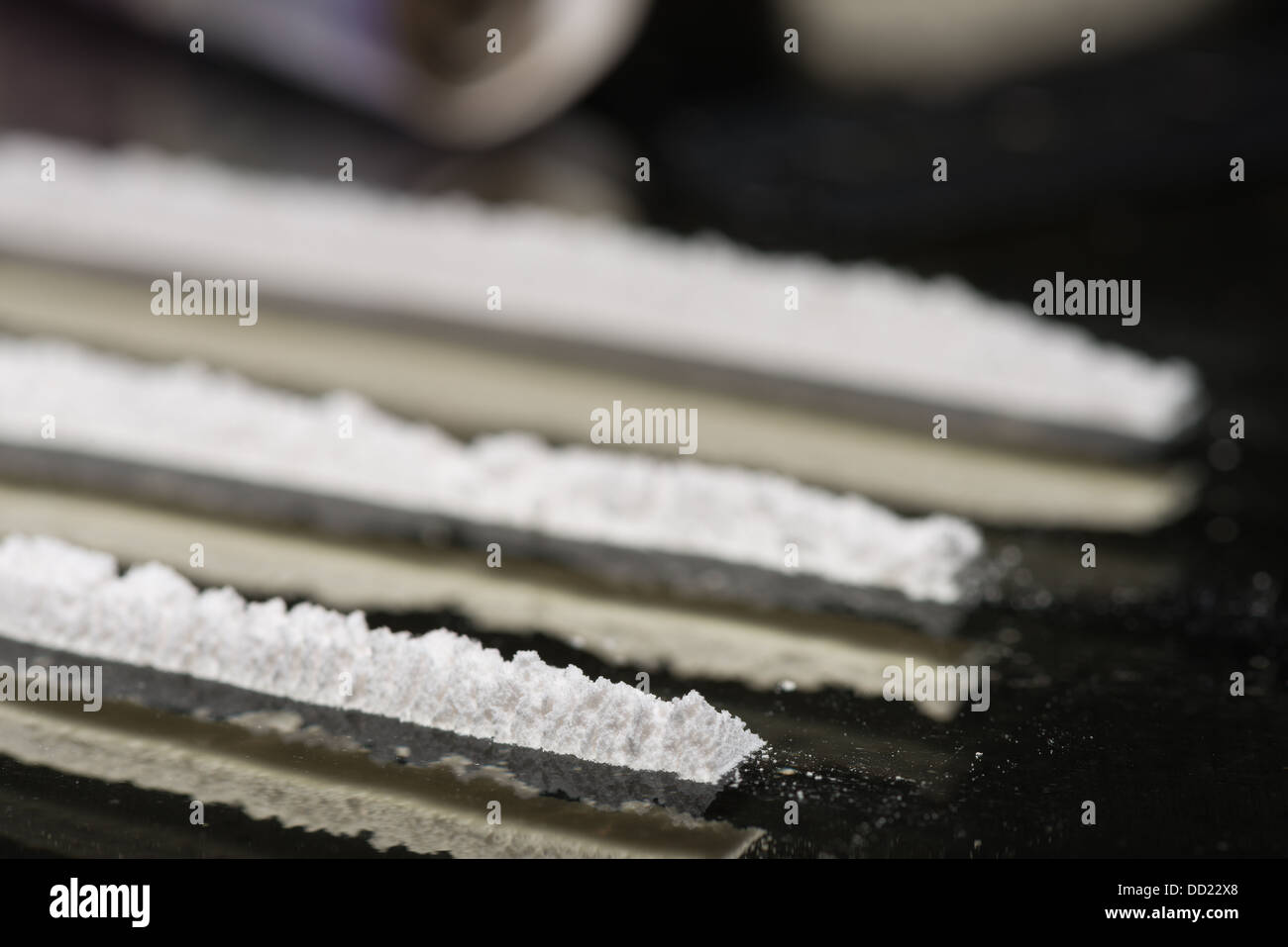 Drug addiction lines rows of powdered cocaine ready to be snorted representing a bad drug habit out of control life destroying Stock Photo