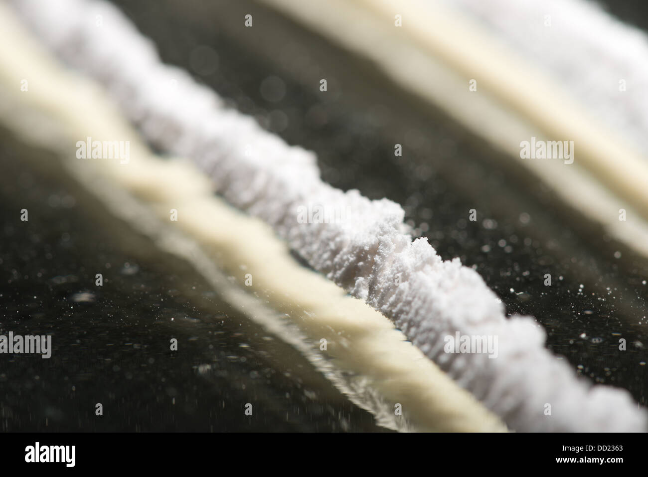 Drug addiction lines rows of powdered cocaine ready to be snorted representing a bad drug habit out of control life destroying Stock Photo