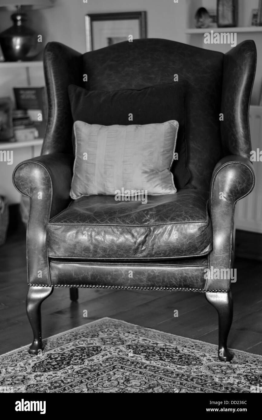 A Black and White Picture of an Arm Chair in Living Room Stock Photo