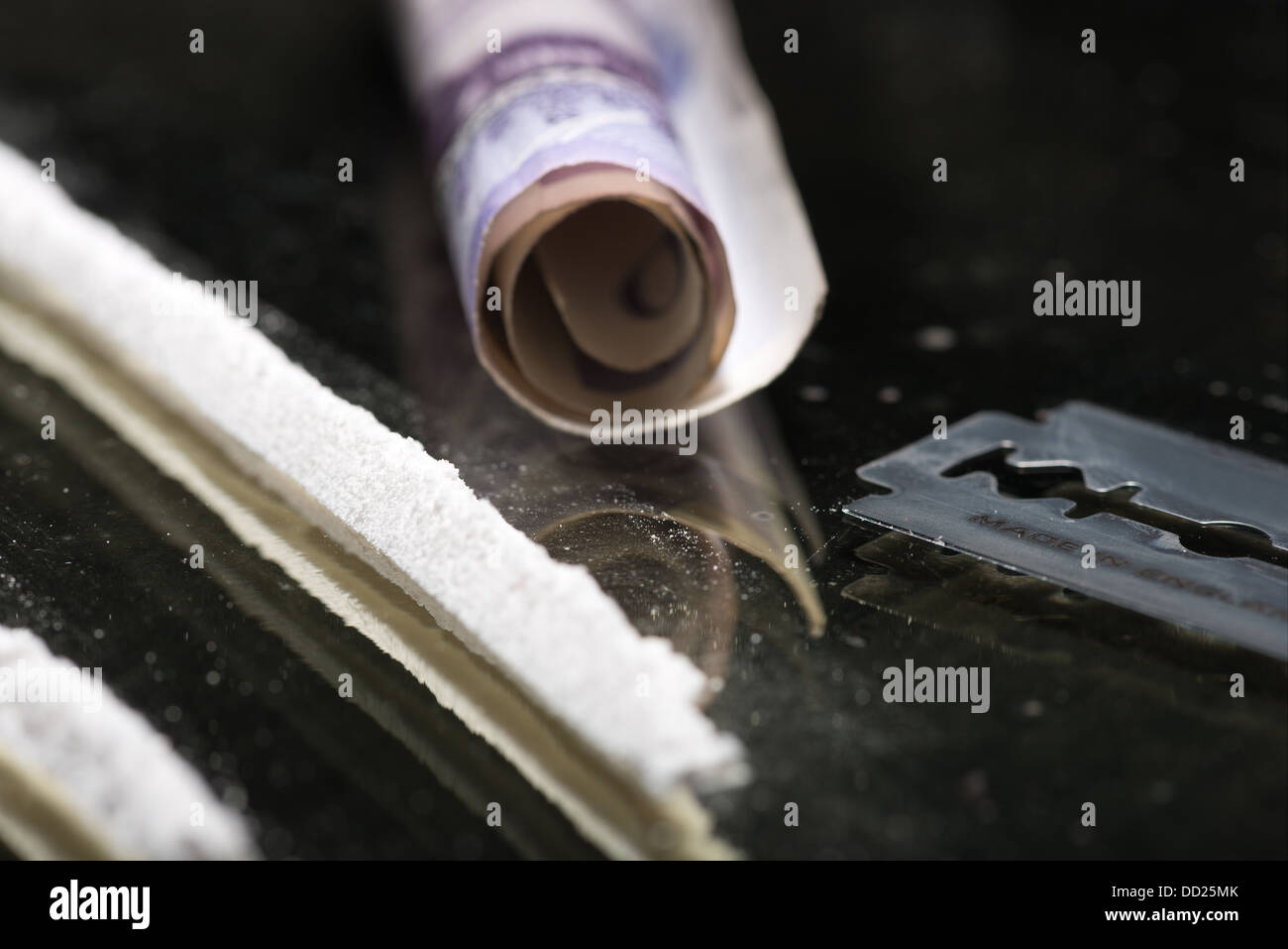 Drug addiction lines rows of powdered cocaine ready to be snorted representing a bad drug habit out of control life destroying Stock Photo