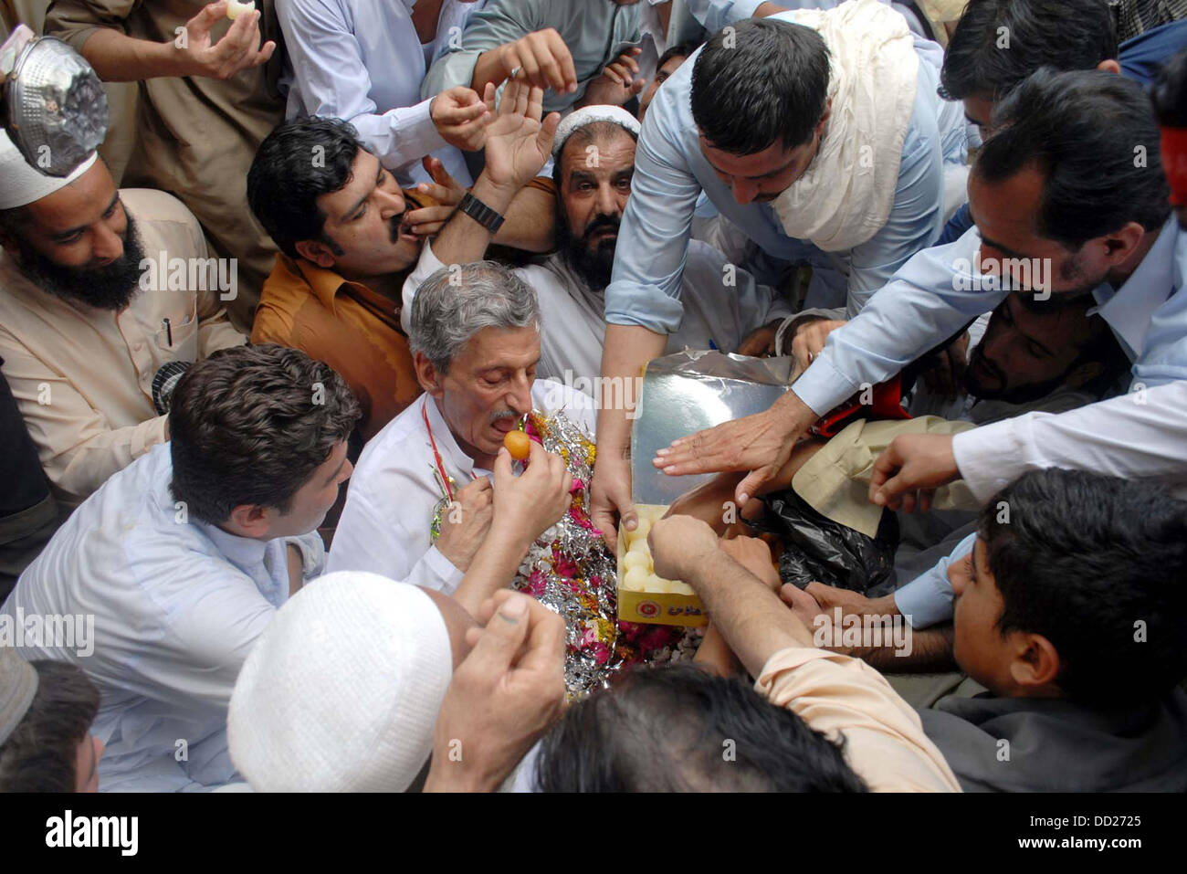 Awami National Party (ANP) Leader, Haji Ghulam Ahmad Bilour meets to his supporters after his victory in By-Election 2013 for NA-1 during celebration in Peshawar on Friday, August 23, 2013. Stock Photo