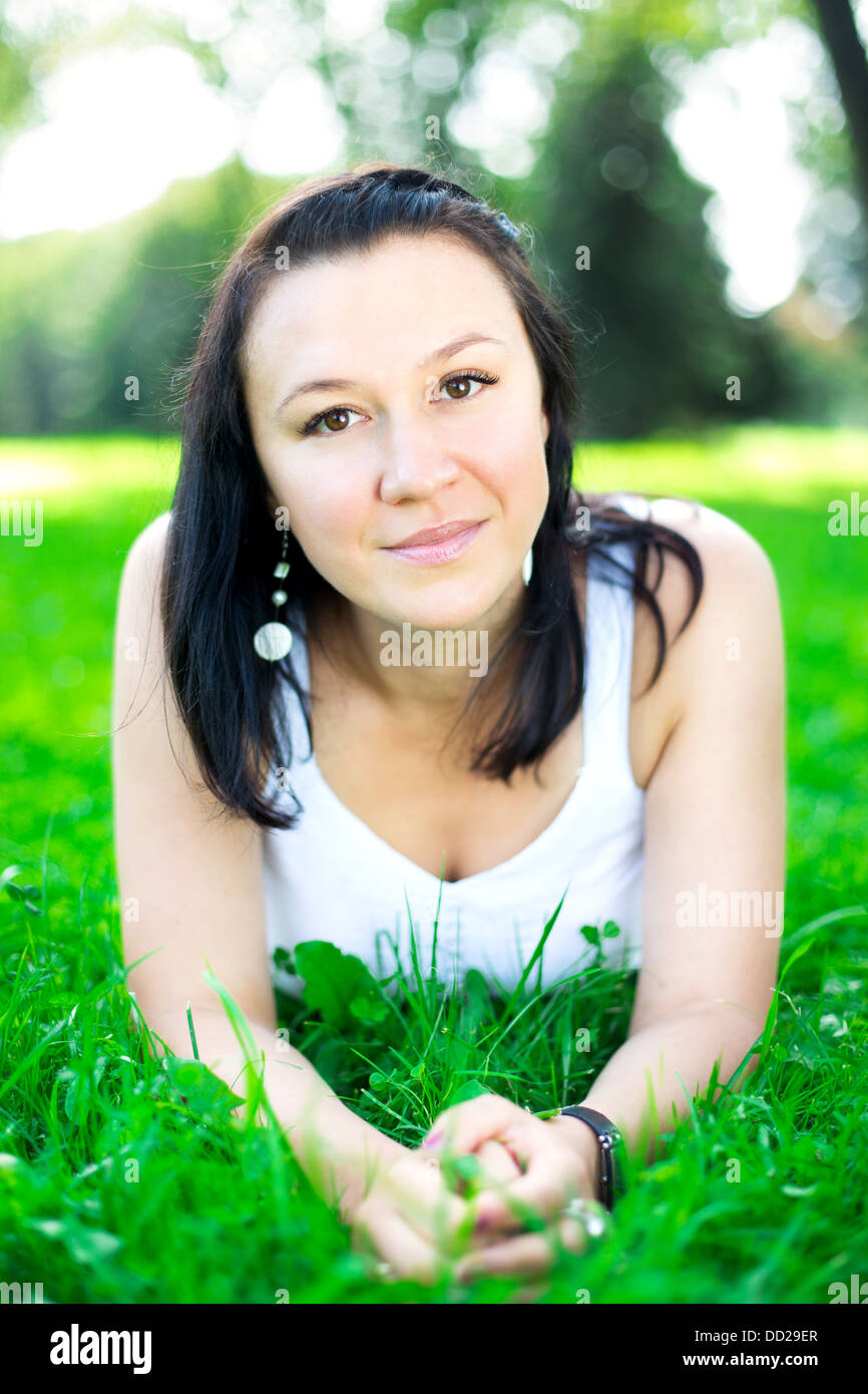 Beautiful girl lying on a grass Stock Photo - Alamy