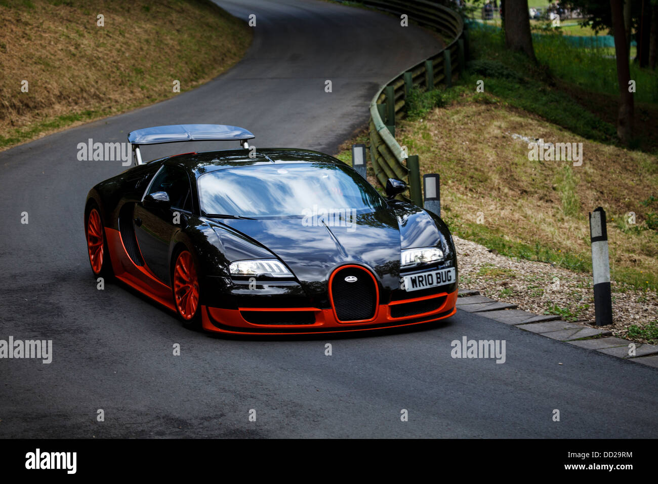 A orange and black Bugatti Veyron Super Sport on the track at Prescott Hill, Gloucestershire, England Stock Photo