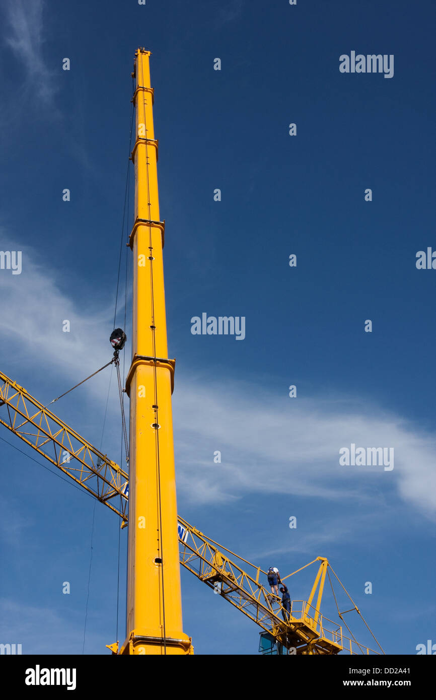view of crane lifting crane boom into position for assembly Stock Photo Alamy