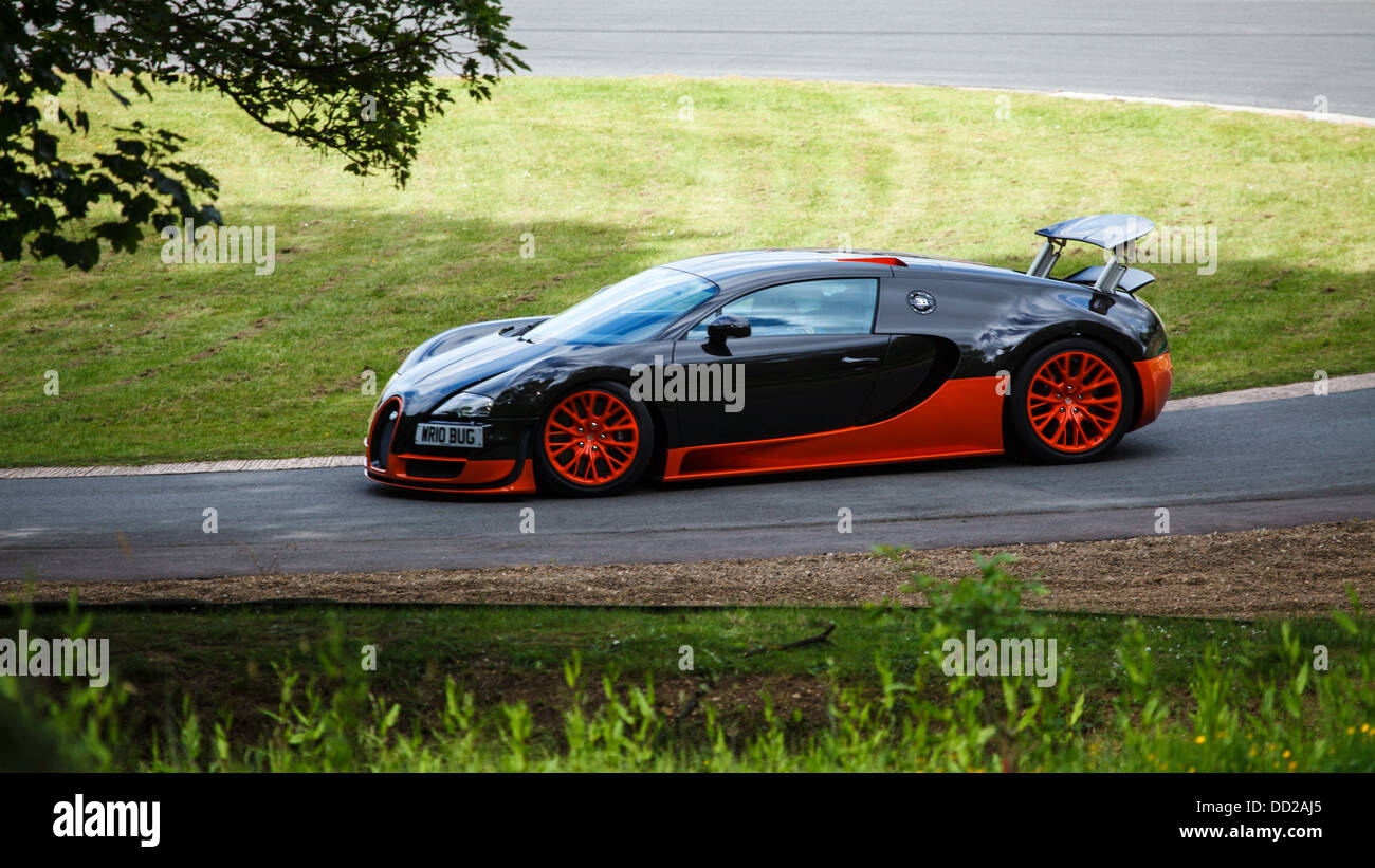 A orange and black Bugatti Veyron Super Sport on the track at Prescott Hill, Gloucestershire, England Stock Photo