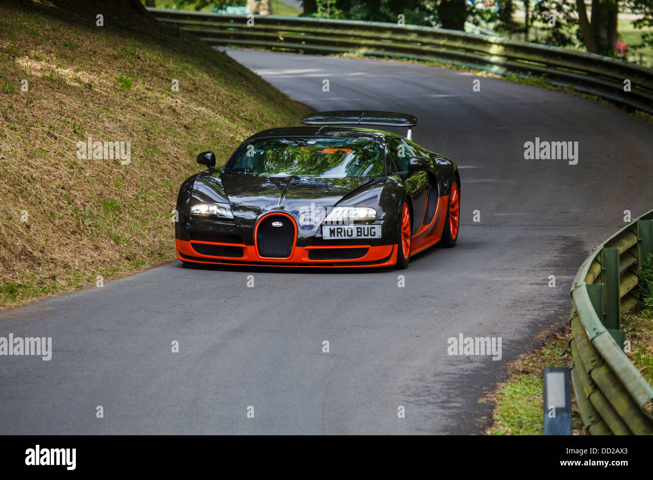 A orange and black Bugatti Veyron Super Sport on the track at Prescott Hill, Gloucestershire, England Stock Photo