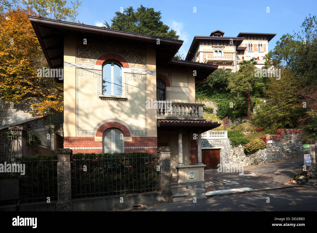 Front view of large, multilevel old house with coach house, in Northern