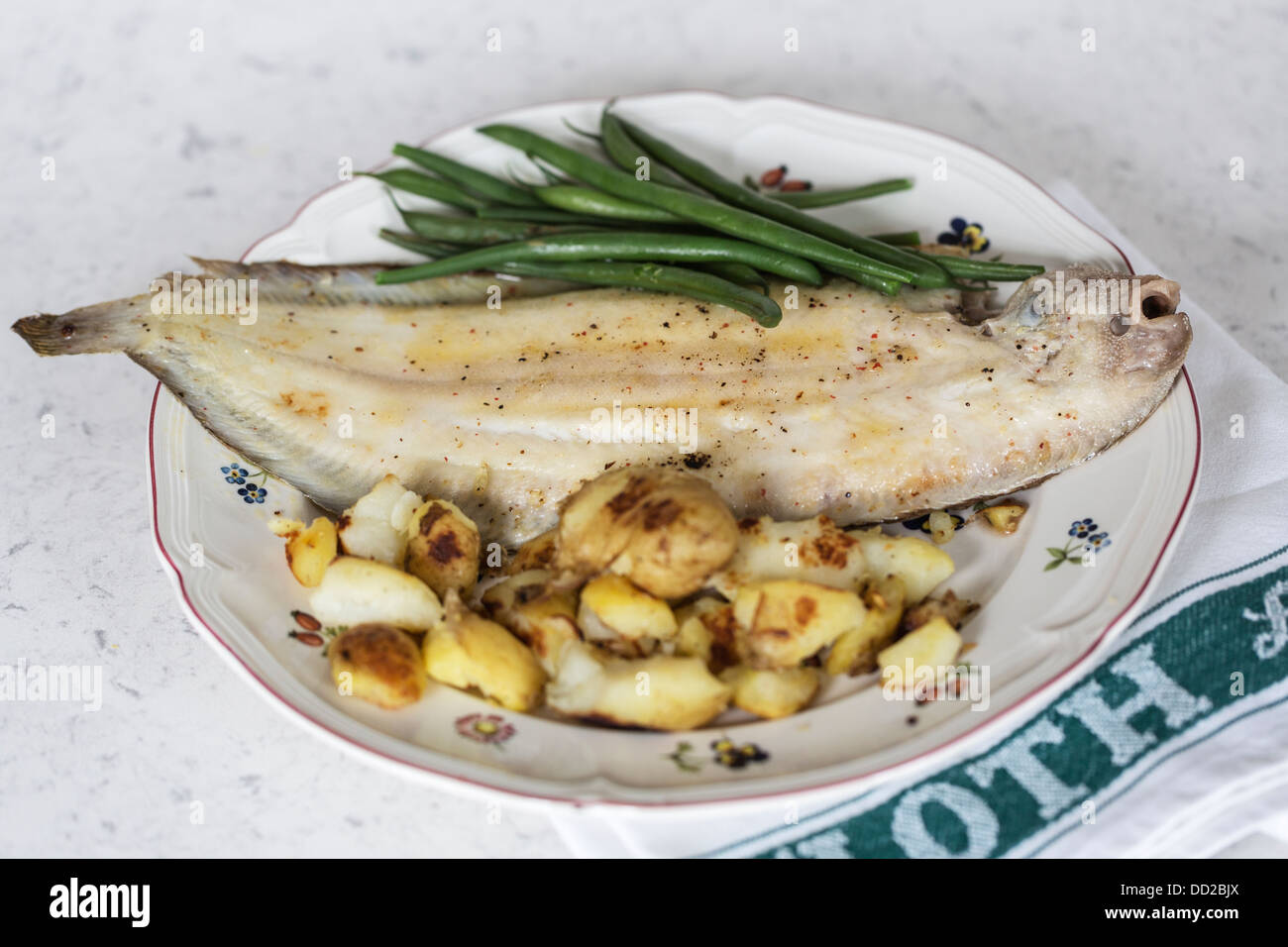 Grilled Dover sole with sautéed new potatoes and green beans Stock Photo
