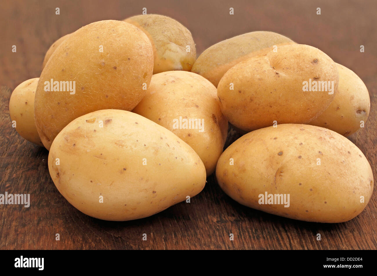 fresh potatoes on oak table Stock Photo Alamy