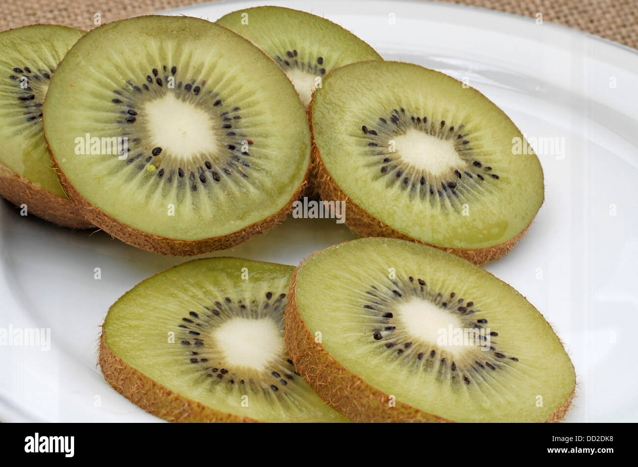 Kiwi slices on white plate Stock Photo